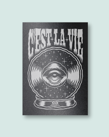 Screen print with 'C'est La Vie' text and eye in a crystal ball design on black paper